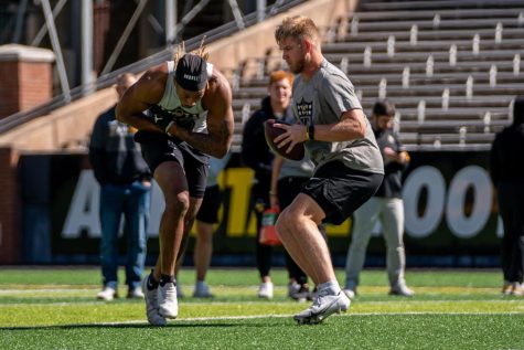 Quarterback Chase Brice fakes the handoff to running back Cam Peoples during App States Pro Day March 30, 2023. 