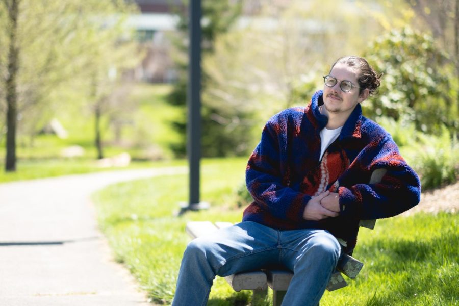 Landon Webb, a senior commercial photography major, poses for a portrait in Durham Park.