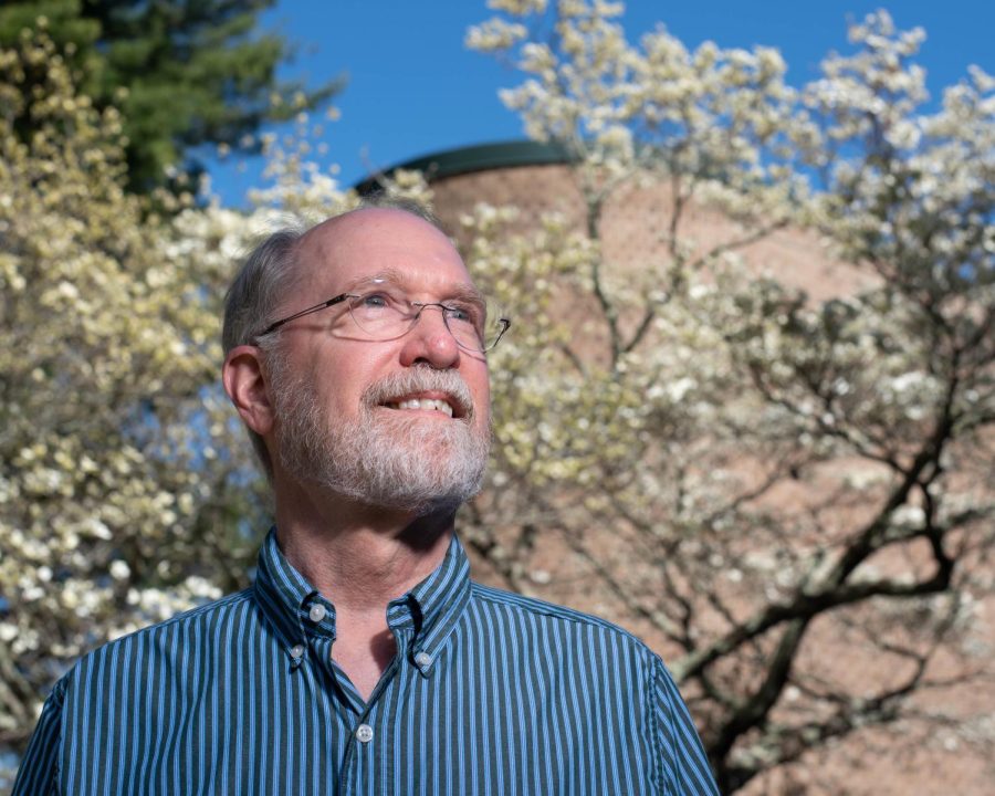 Victor Mansure, Music History Area Coordinator in the Hayes School of Music, poses for a portrait outside Broyhill Hall, April 12, 2023. Mansure has lived in over half a dozen states, but plans to retire in the High Country. 