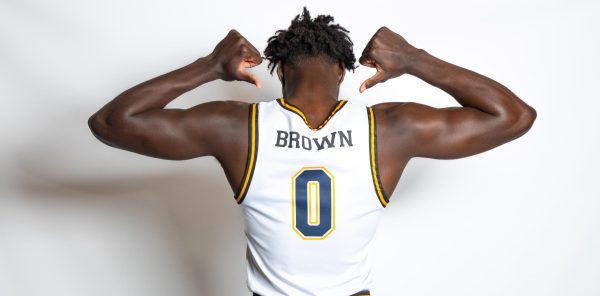 Junior guard Xavion Brown shows off the new home white jersey Sep. 13, 2023.