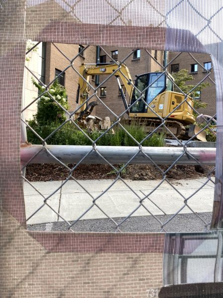 An excavator sits outside Wey Hall during the renovation process. 