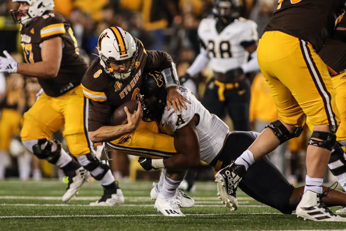 Redshirt senior linebacker Andrew Parker Jr. sacks Wyoming quarterback Andrew Peasley Sept. 23. The Mountaineer defense gave up only 31 passing yards in the loss.
