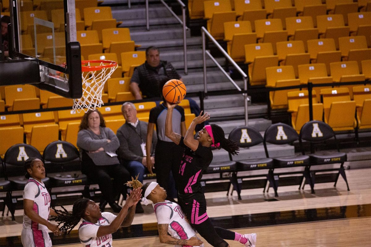 Guard Janay Sanders, class of 2023, shoots a layup against the Troy defense.