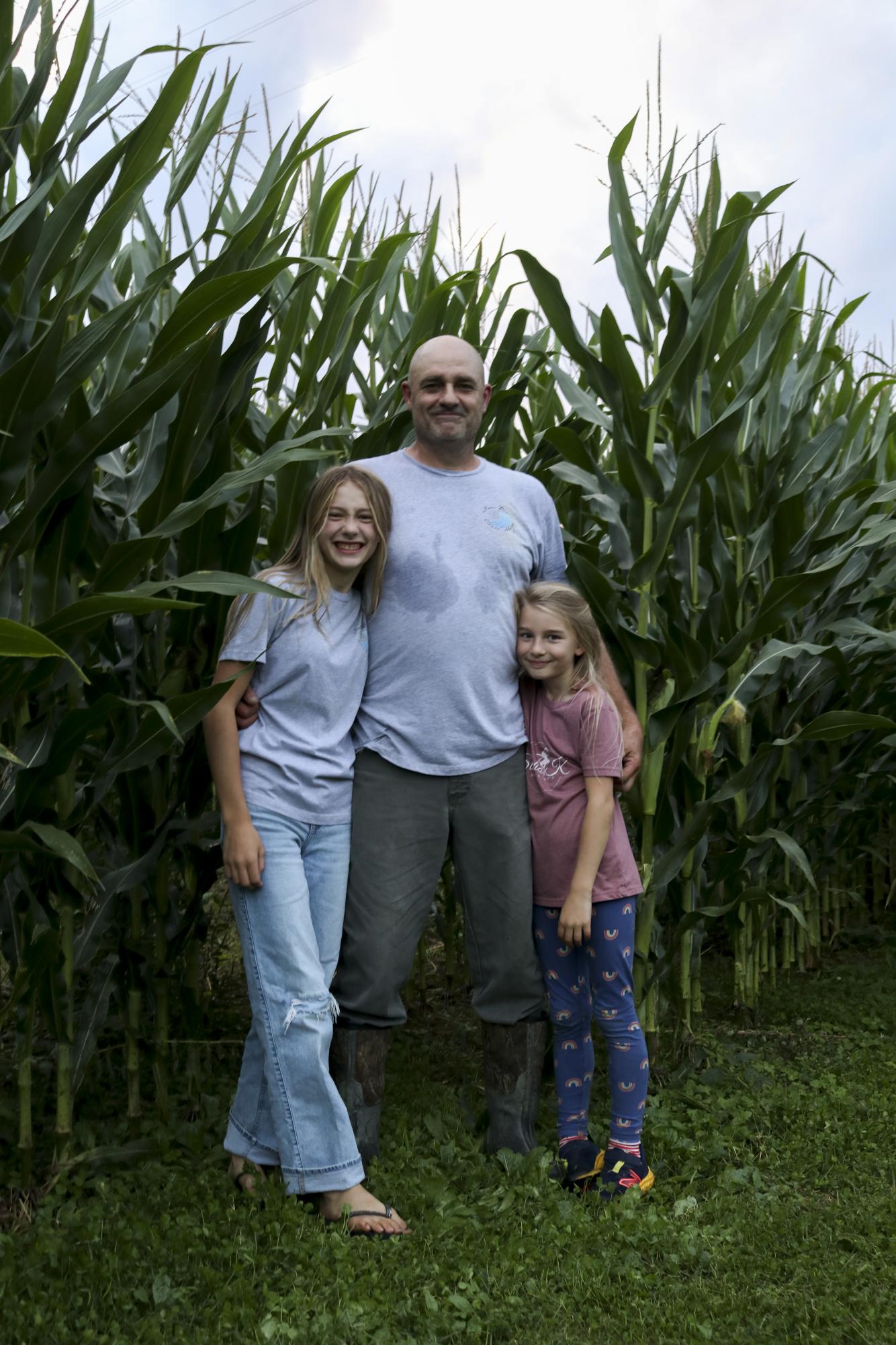 Owner, David Tucker and his two daughters, Coco (left) and Ellee (right) stand proudly in front of their corn maze they’ve spent the summer preparing. Sep. 14, 2023 