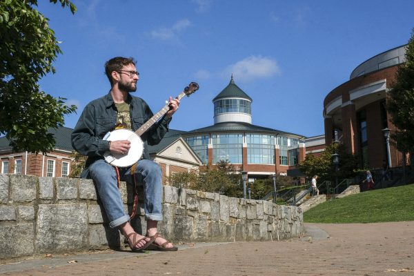 Enthomusicology Senior Caleb Hignite plucks his banjo out on Sanford Mall. Oct. 5, 2023. 