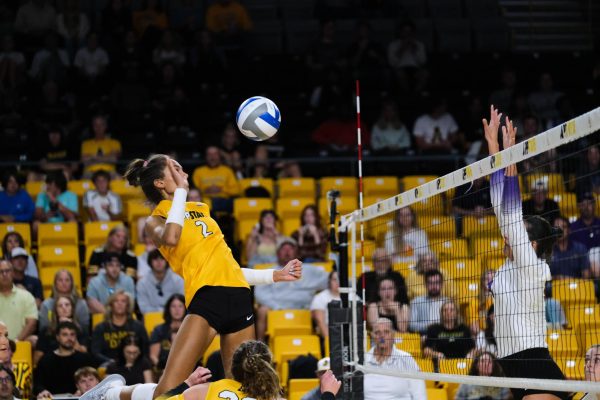Sophomore middle blocker Maya Witerhoff goes up for a slam against James Madison Sept. 23.