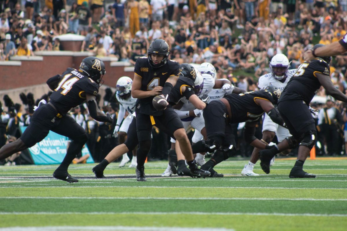 Junior quarterback Joey Aguilar hands the ball off to redshirt freshman running back Kanye Roberts during App States 43-28 win over ECU Sept. 16.