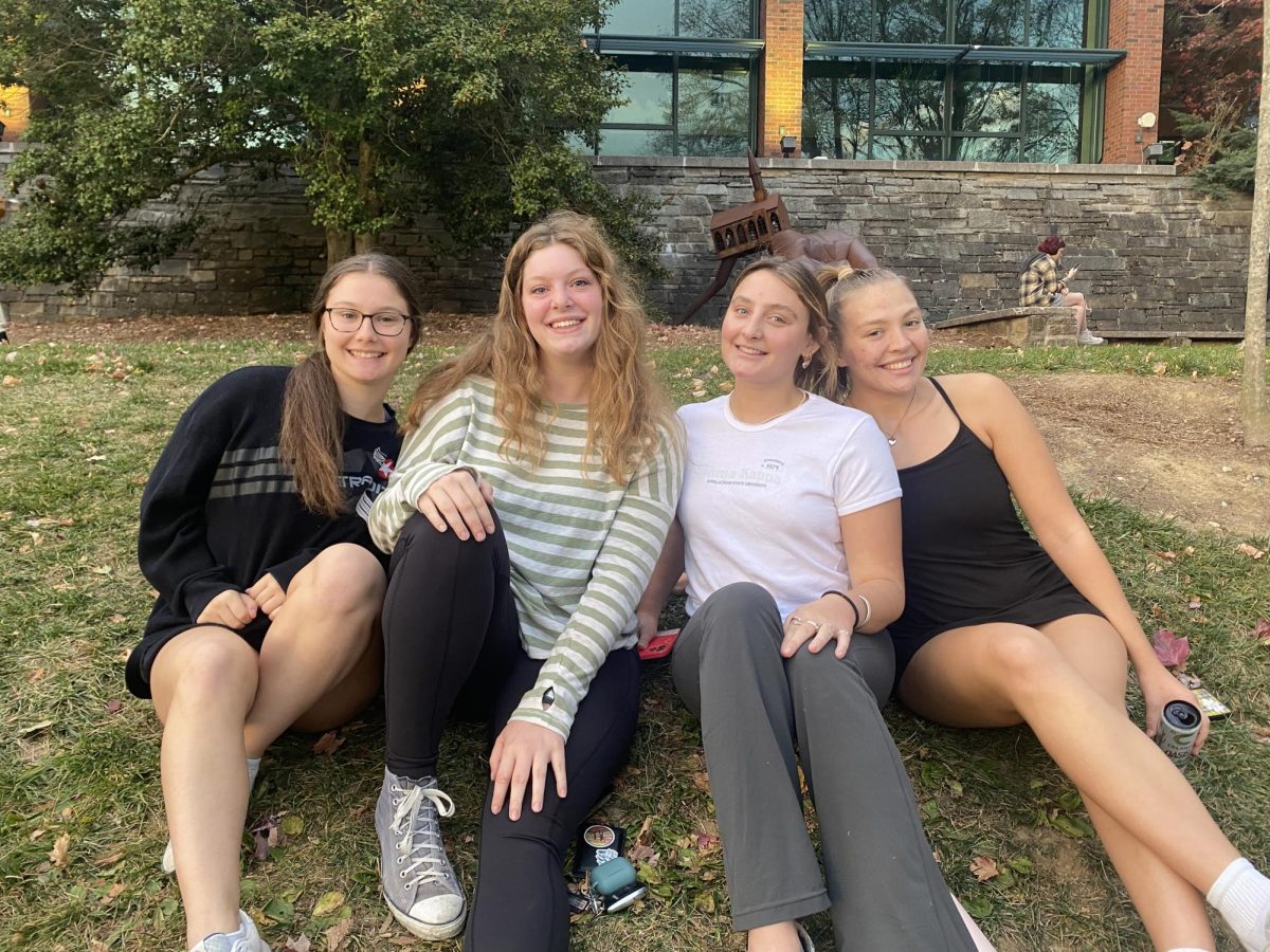 From left to right, second year Club Cheer member Jessica Gott, second year member Hanna Frazier, fourth year Addie Layne, and fourth year Sophie Orcutt. “Everyone’s happy to be here, which is awesome,” said Orcutt on Nov. 9, 2023. Photo by Ashton Woodruff. 