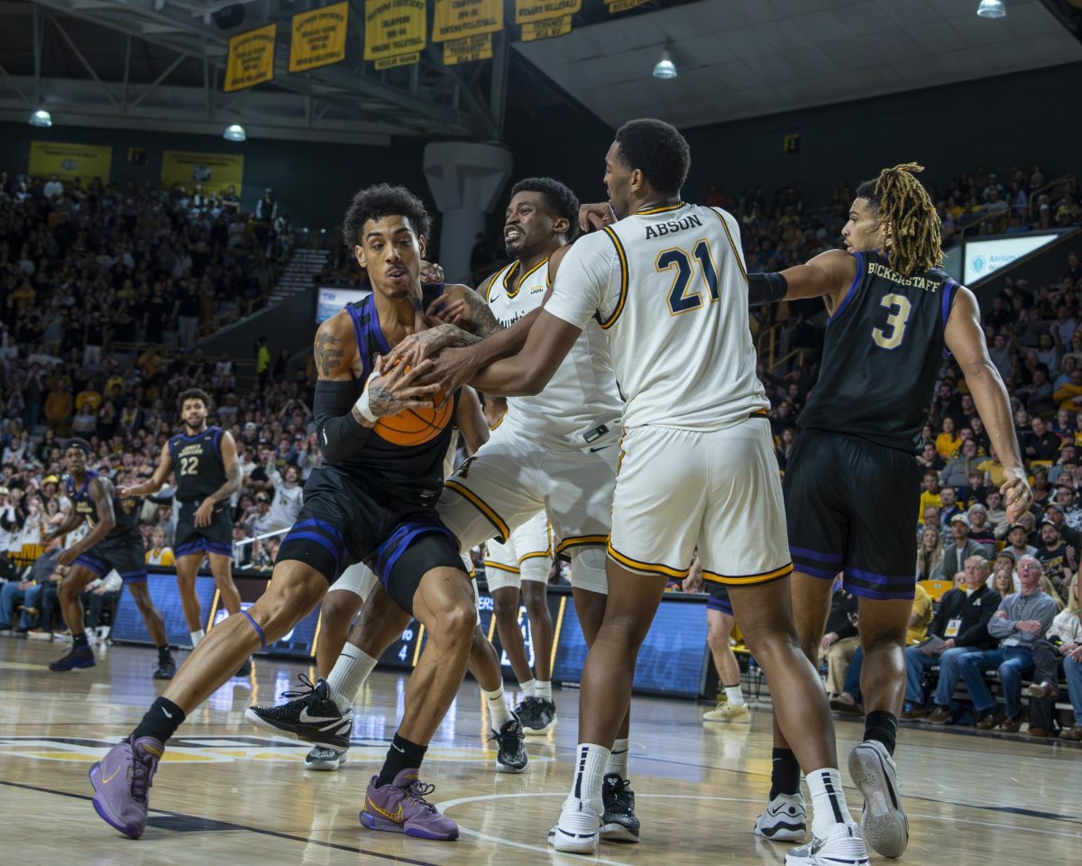 Graduate student forward Donovan Gregory and sophomore forward Justin Abson battle for possession of the ball with the Dukes Terrance Edwards Jr Jan. 27. The Mountaineers held James Madison to 42% shooting from the field.