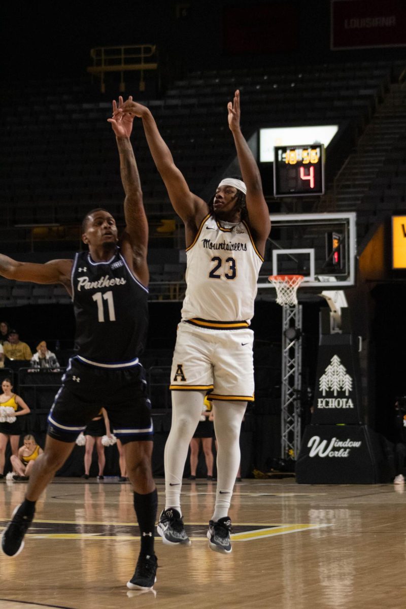 Junior guard Terence Harcum takes a jumpshot agaist Georgia States Toneari Lane Jan. 17, 2024. Harcum had eight points and two rebounds in App States 76-68 win.