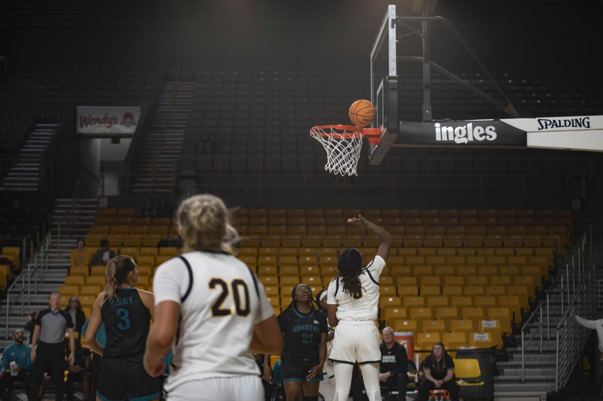 Senior guard Taylor Lewis shoots for two points against Coastal Carolina’s Makaila Cange. Lewis scored 11 points and 4 rebounds during the game Jan. 18, 2024.