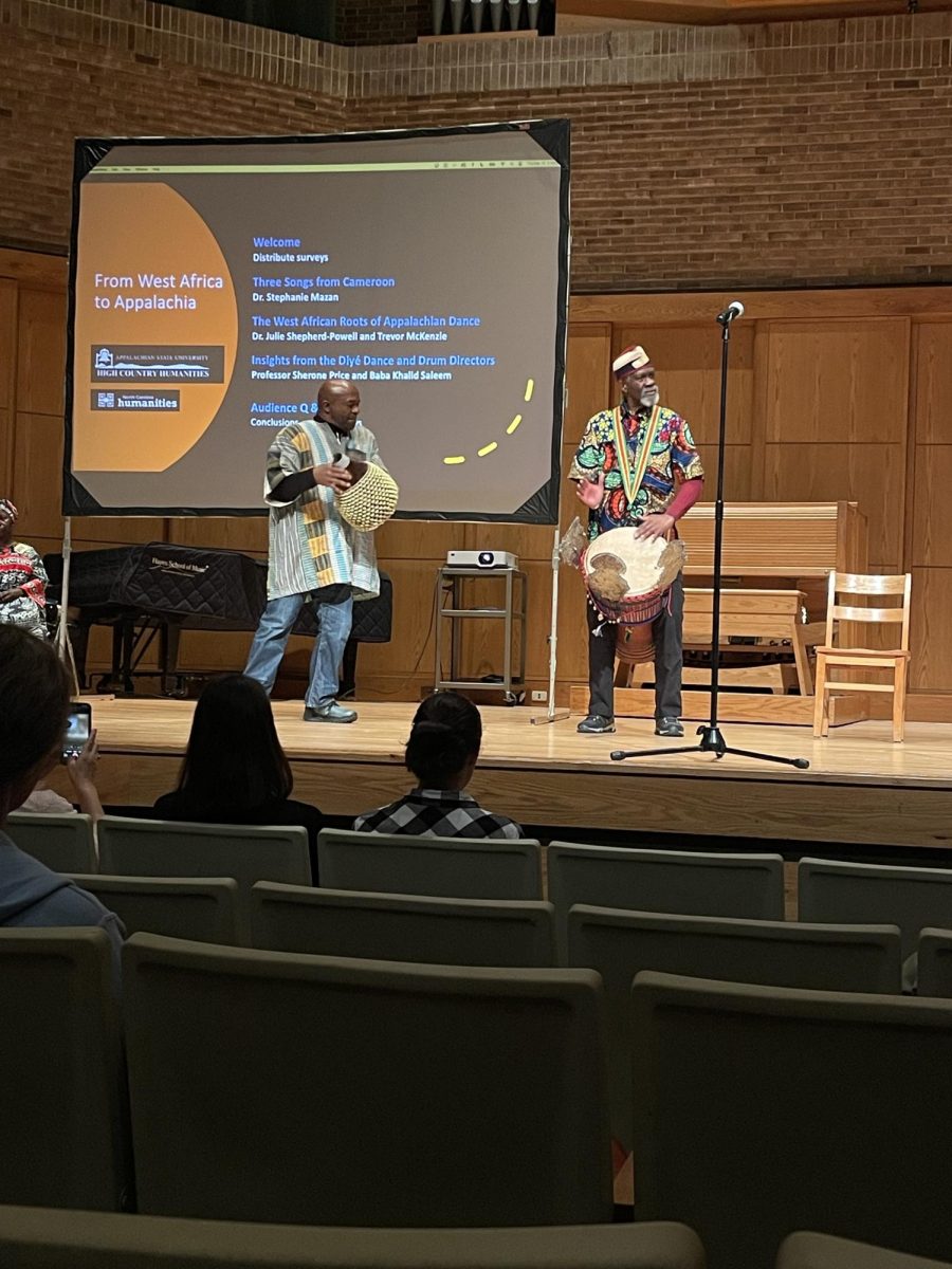 Sherone Price, professor of African Dance (left) and Khalid Abdul N’Faly Saleem, instructor of African Drumming for Dance (right) lead the audience in a call and response song on Feb. 15, 2024. The song explained how the drum Khalid was using, called a djembe, was made.