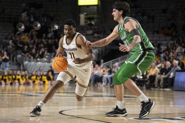 Graduate student forward Donovan Gregory drives past a Marshall defender Feb.15. After the win over the Thundering Herd, App State holds sole possession of first place in the Sun Belt.