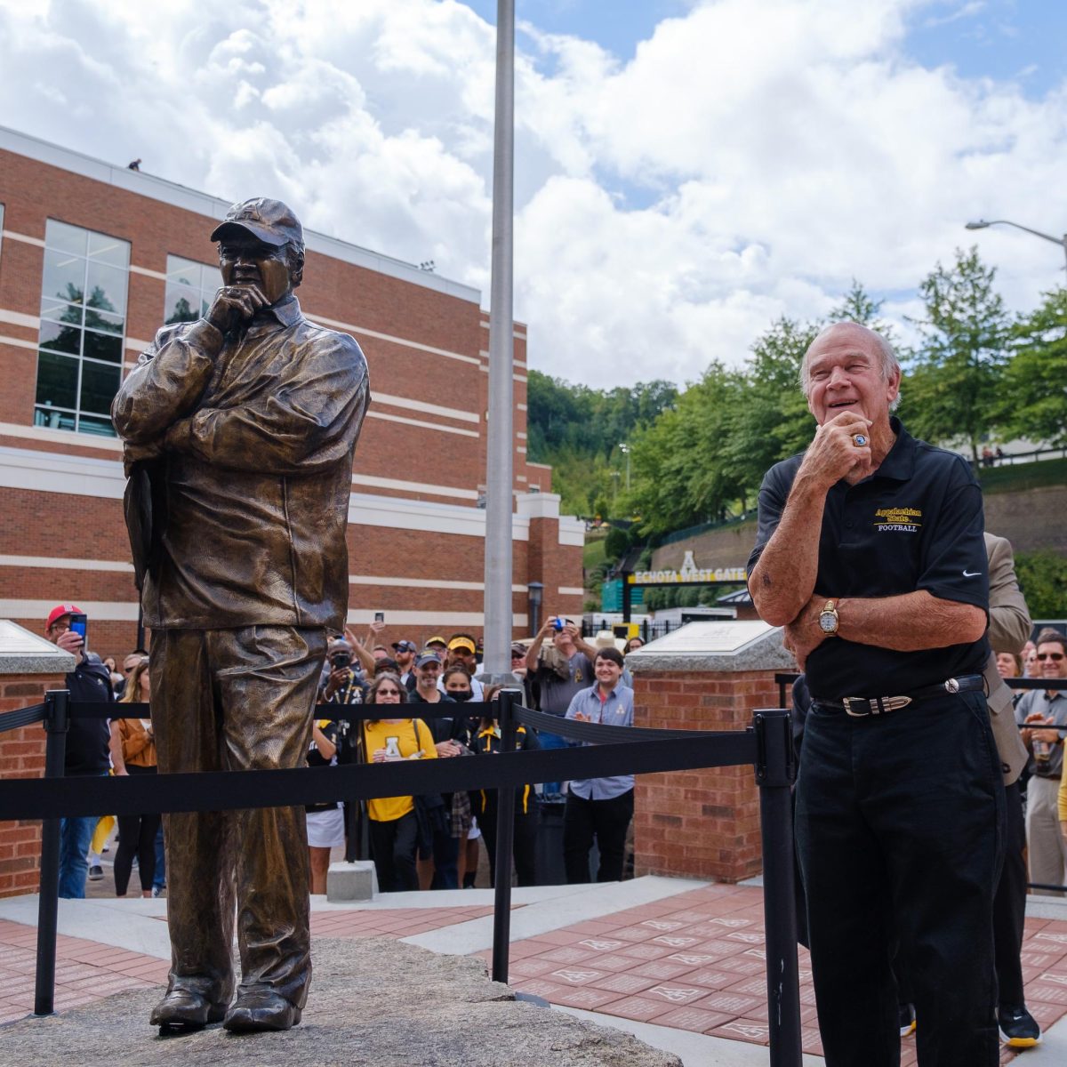Jerry Moore matches his statue’s pose during the unveiling of the statue and the plaza dedicated to him outside the front of Kidd Brewer Stadium on Sept. 18, 2021. Moore was the head coach of App State football for 24 years where he went 242-134-2 and led the team to three NCAA Division I-AA Football Championships in a row, the first national championships for any North Carolina college football team.