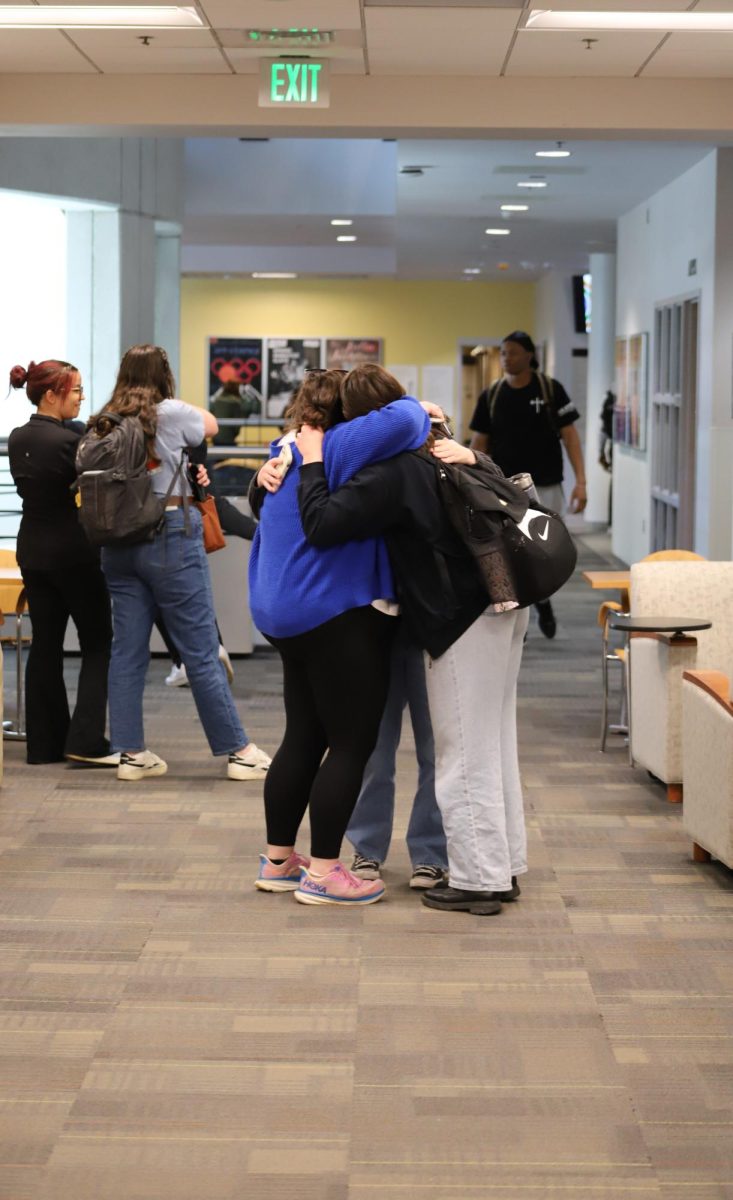 Newly elected Kathryn Long and Amarah Din embrace after winning the election for 2024-25 SGA student body president and vice president on March 28.