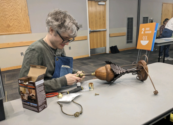 Andrew Groothuis, Repair Hub’s ambassador, twists and turns the wires in an acorn-shaped lamp in hopes of restoring it to its former glory on Mar. 2. 
