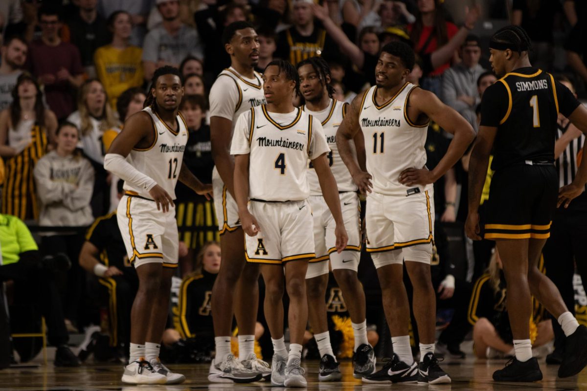 The+Mountaineers+gather+around+during+a+timeout+against+Toledo+Feb.+10.
