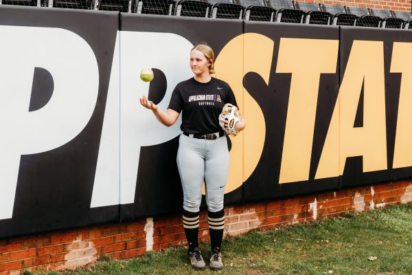 Senior outfielder Kayt Houston tosses a ball in the air.  Houston holds the schools career hit record at 239.