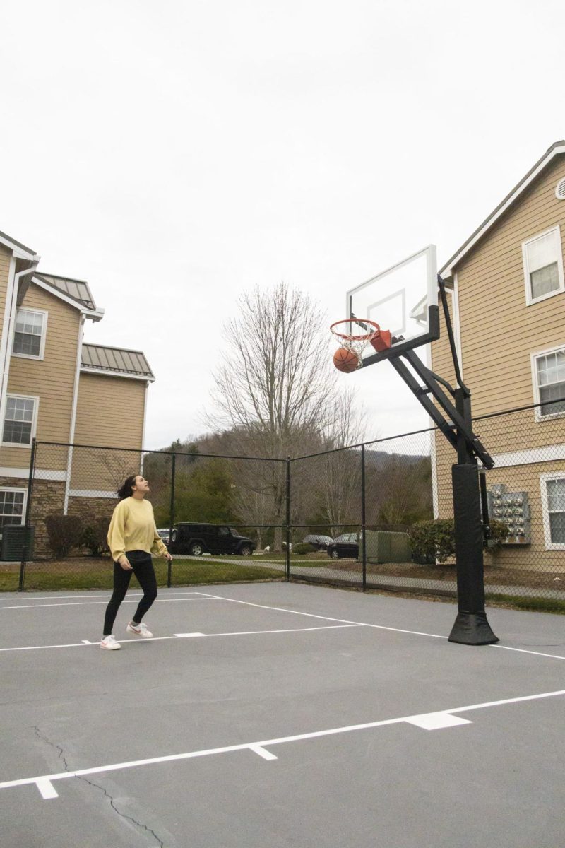  Resident Julie Salvatierra shoots hoops at the University Highlands basketball courts on March 5. The Highlands amenities also include a pool, hot tub and tennis courts.