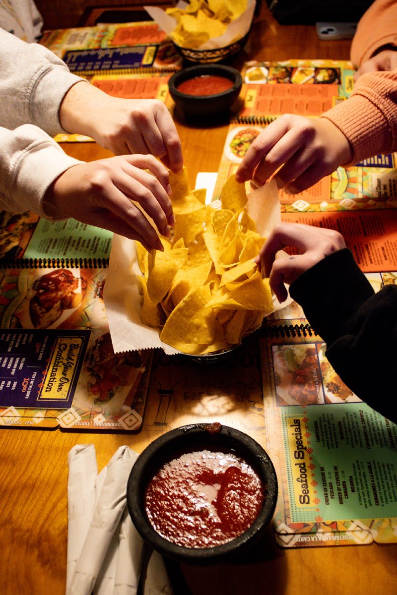 Customers reach for chips and salsa at Los Arcoiris on March 6. The delicious appetizer is one of the many reasons people are drawn to Los.
