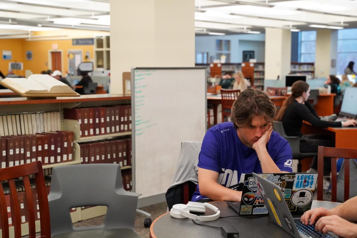 Junior Chase Viscuse focuses on an assignment on March 6, seated on the first floor of Belk Library.