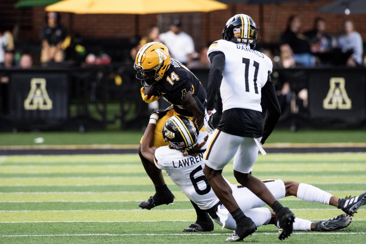 Sophomore running back Kanye Roberts dodges a tackle by Southern Miss safety Dylan Lawrence on Oct. 28. Roberts has played with the Mountaineers since the 2021 season.