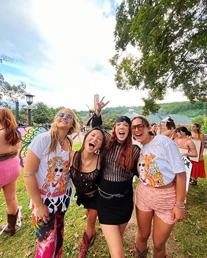 Chi Omega sisters enjoy a groovy bid day as four sisters gather to meet their new recruits. Chi Omega is known for their community and campus involvement. Courtesy of Chi Omega