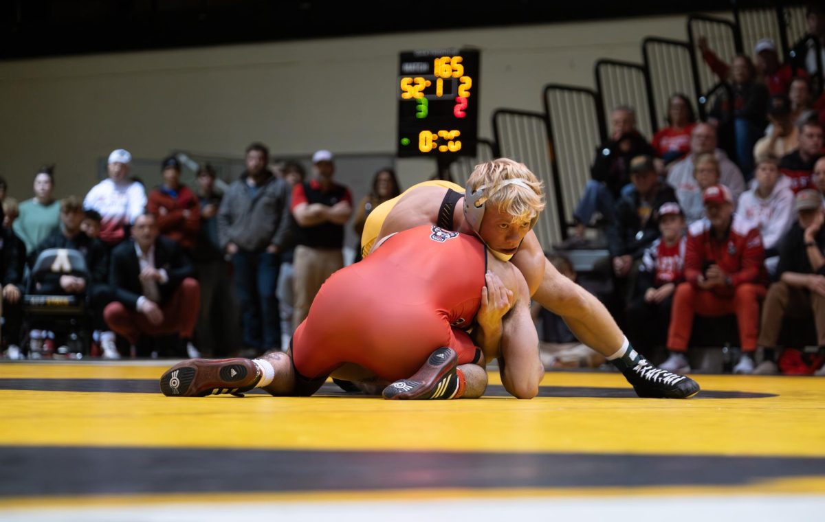 Will Miller pins down an NC State wrestler at the Varsity Gym on Nov. 4. Miller had 54 points in 13 dual matches for the 2023 season.