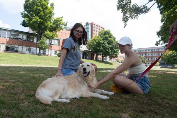 Two App State students enjoy Izzy’s presence at Sanford Mall on Aug. 29. She was found by Senior Associate Director and Director of Clinical Services Chris Hogan. 
