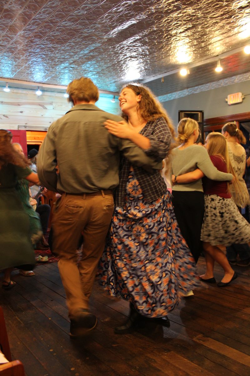 Two locals dance together at the Todd Community Dance on Sept. 13. The event consists of live music and is preceded by a potluck dinner.