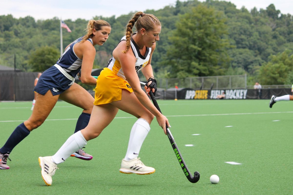 Junior midfielder Samantha Connors dribbling past Georgetown opponent on Sept. 1. In the 2023 season, Connors was named to the Academic All-MAC team as a sophomore.