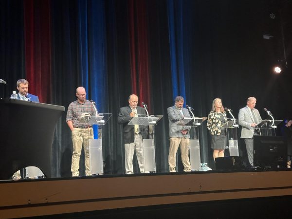 From left, Watauga County Commissioners candidates Braxton Eggers, Jon Council, Ronnie Marsh, Charlie Wallin, Sue Sweeting, and Todd Castle gather at the Appalachian Theatre of the High Country on Sept. 16.