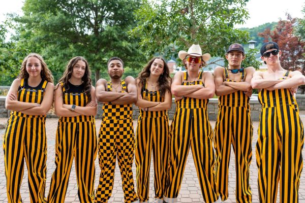 From left, Gracie McDade, Kaylann Pond, Christian Houston, Ryli Mozolak, Matt Hare, Cohen Moody and John Balthrop pose in their game day bibs at a fraternity tailgate at Sanford Mall on Aug. 31. The black and yellow bibs have been a staple game day outfit in recent years. 