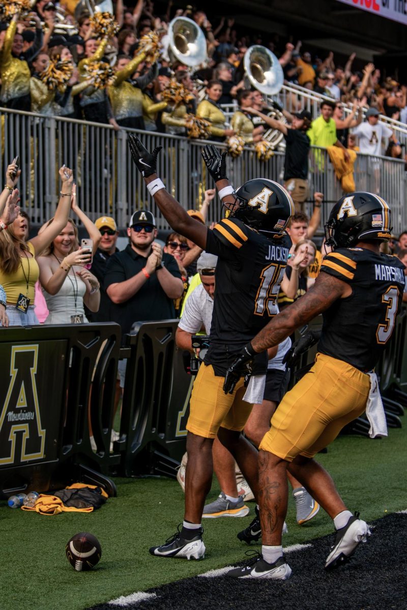 Junior wide receiver Makai Jackson celebrates with fans and teammate Ahmani Marshall after scoring a touchdown on Aug. 31. Prior to App State, Jackson played at Saint Francis in Pennsylvania.