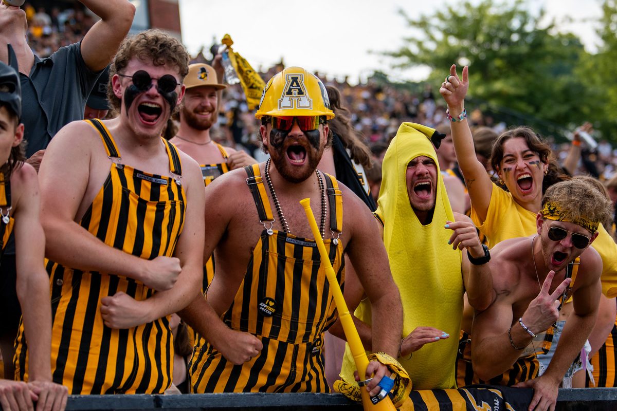 Fans cheer on the Mountaineers front row at the App State vs. ETSU game on Aug. 31. Members of the Student Yosef Club get early access to the football stadium on game days.