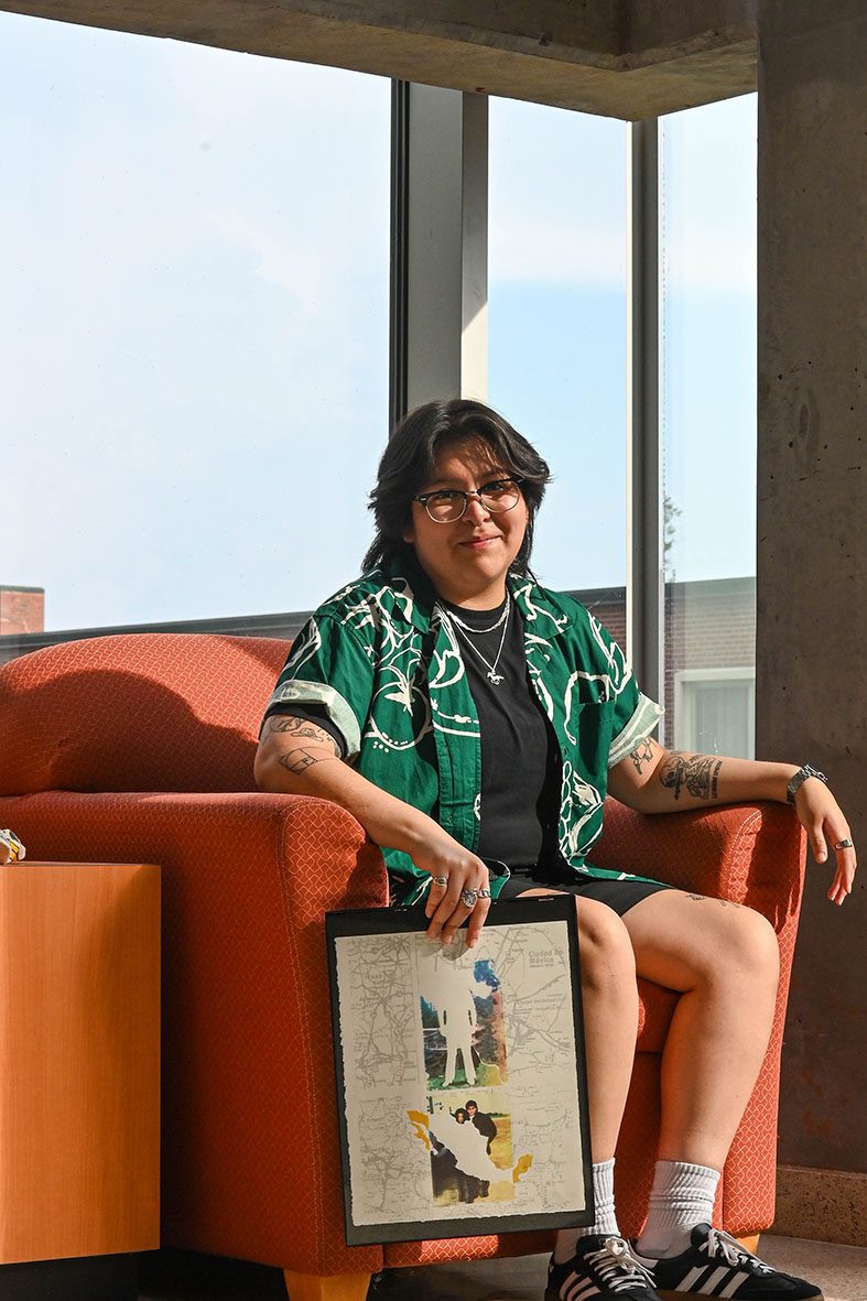 Senior graphic design major Karol Perez sits with her piece “Hasta La Raíz” at
East Hall on Aug. 30. Perez states their work is vital to her to stay close to the
culture in which they come from.