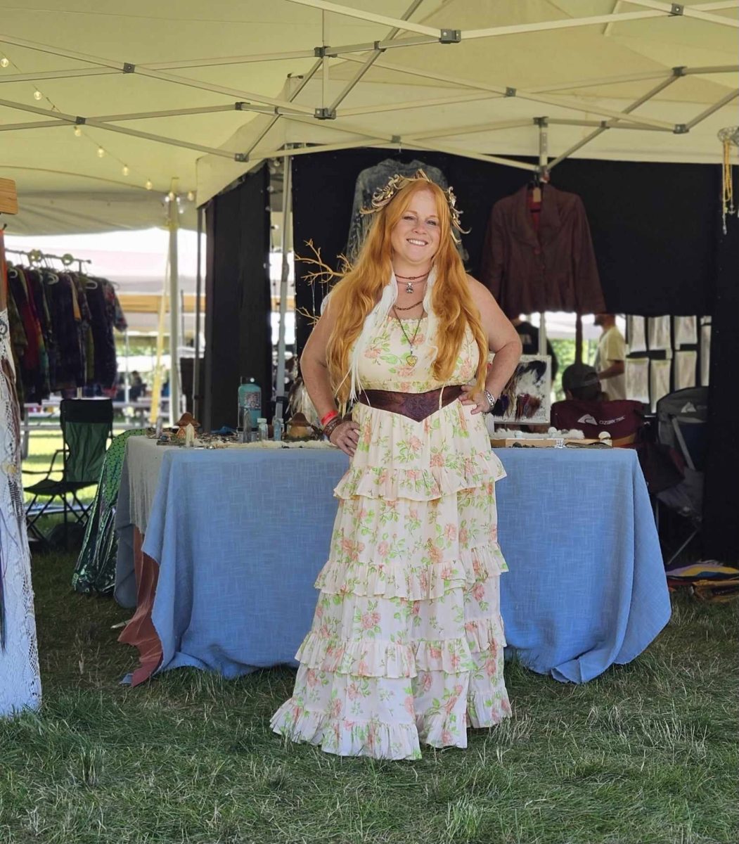 The owner of Barefoot and Brazen Kelly Mosenfelder poses in front of her booth. Mosenfelder sells handmade jewelry and other handmade items. 