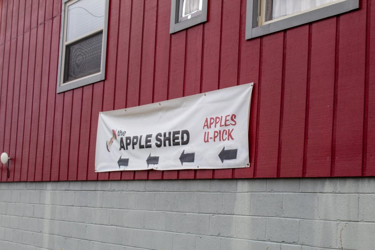 A sign on the general store directs visitors to the apple shed to start their apple picking experience at the Altapass Orchard on Sept. 14. Altapass offers guided ‘U-Picking’ tours during apple picking season.