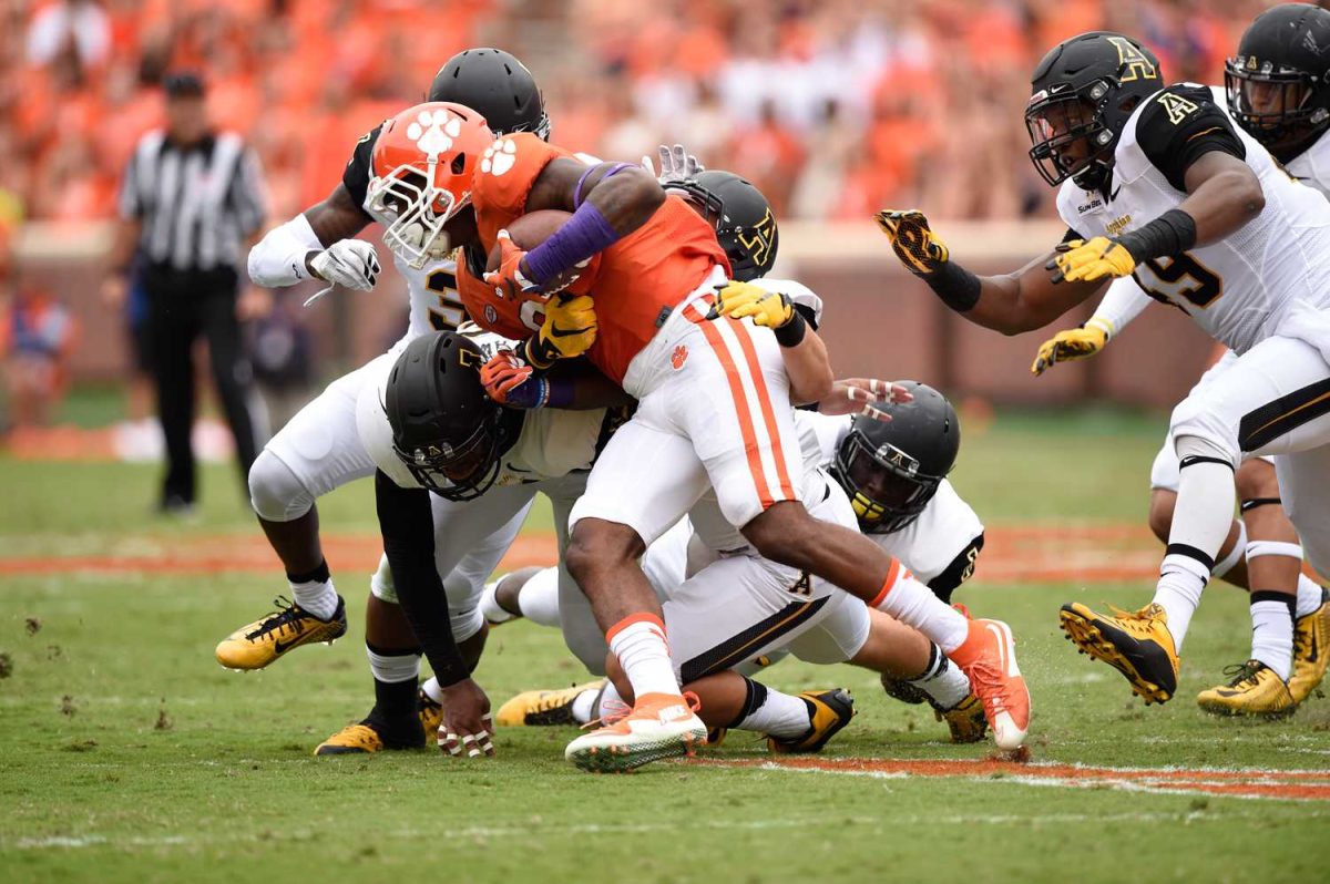 Mountaineers fight to bring down a Clemson player at Memorial Stadium on Sept. 12, 2015. App State has not played the Tigers since 2015.