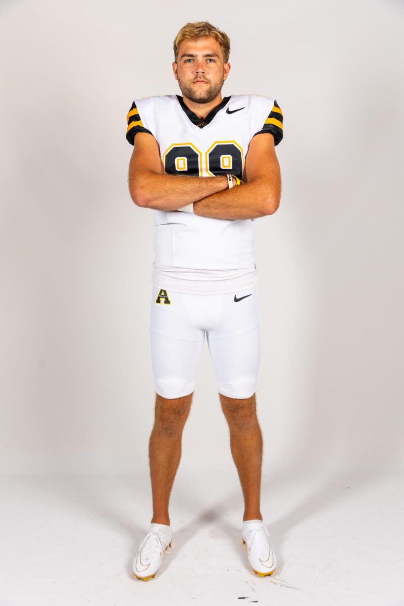 Michael Hughes poses cross armed at media day on July 9. Hughes totaled 188 points in the 2022-23 season as kicker.