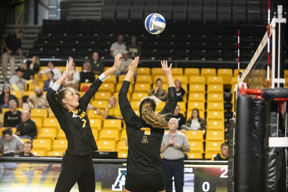 Setter Addison Heidemann sets up the kill for middle blocker Ava Leahy against Coastal Carolina on Oct. 24. Heidemann had 2 kills and Leahy had 12 in the Mountaineers’ victory.