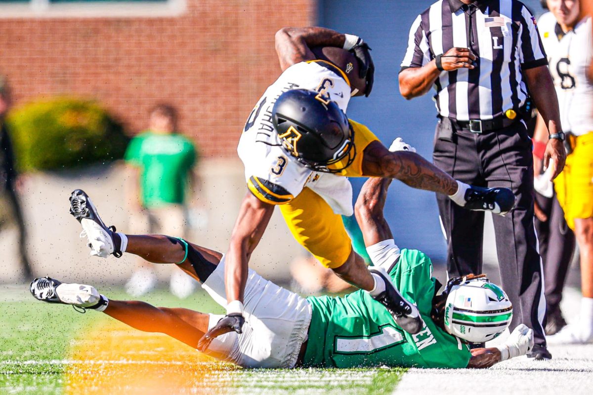 Running back Ahmani Marshall breaks a tackle from a Marshall player at the App State vs. Marshall game on Oct. 5.