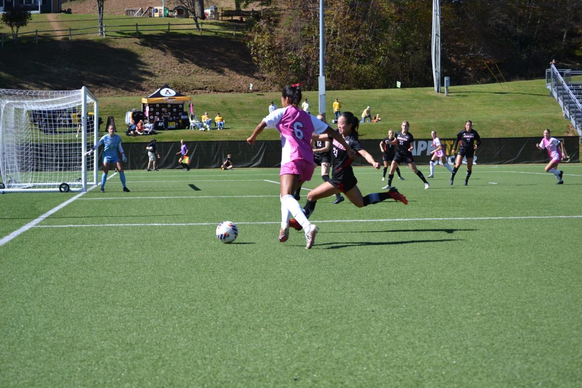 Forward Stephanie Barbosa prepares to cross the ball while shielding off Arkansas State defender Mckenzie Robinson. Barbosa has four assists and one shot on goal so far this season.