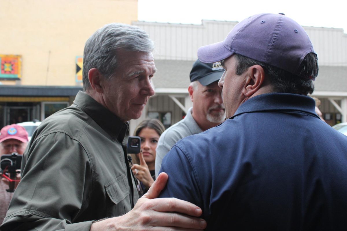 Gov. Roy Cooper speaks with Mayor Tim Futrelle outside the King Street Mast General Store on Oct. 3. 