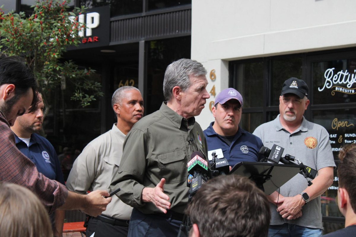 Gov. Roy Cooper answers questions outside Betty’s Biscuits on Oct. 3. 