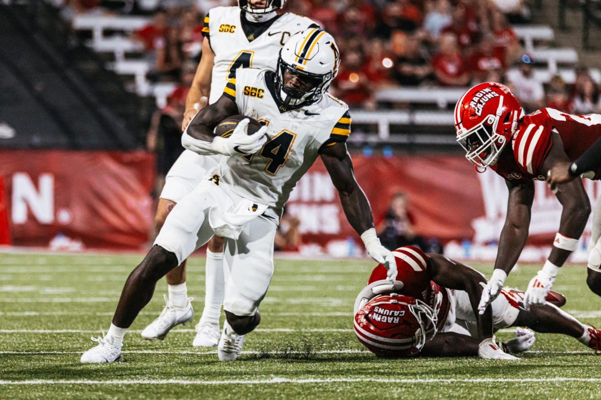 Running back Kanye Roberts dodges a Louisiana defender at the App State vs. Louisiana game on Oct. 12.