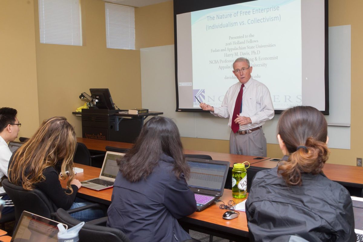 In a classroom, NCBA professor of banking Harry Davis engages his students in the learning process. Five students who came out of Davis’ classes became bank presidents. Courtesy of Walker College of Business