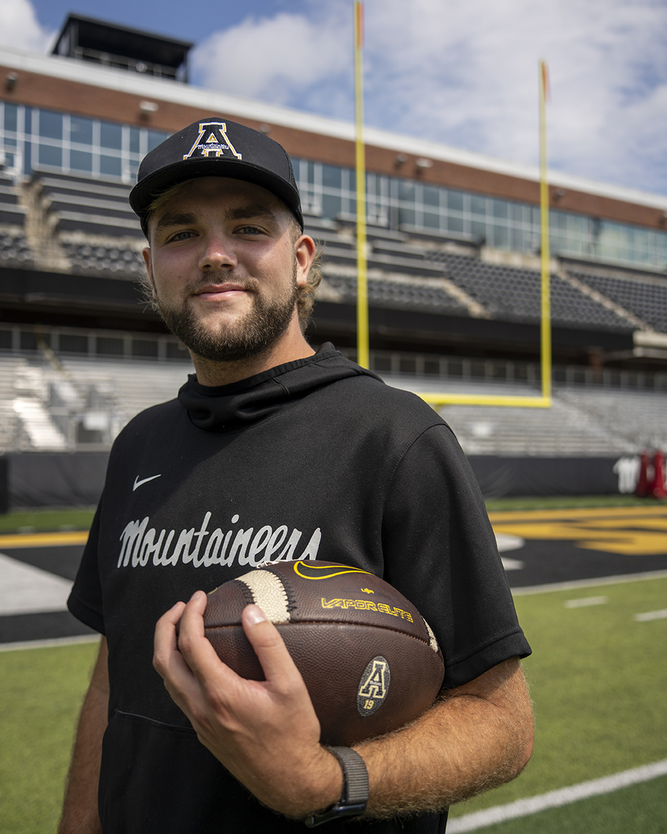 Senior kicker Michael Hughes poses with a football at Kidd Brewer Stadium on Sept. 23. In 2023, Hughes was named the second-team All-American and FBS Special Teamer of the Year by the College Football Network.
