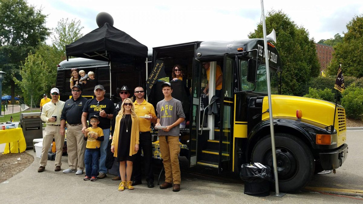 The Gold Squad gathers for a photo in front of their bus on Sept. 9, 2017. They have won several different tailgate of the game awards since the addition of their Appalachian-themed bus in 2010. 