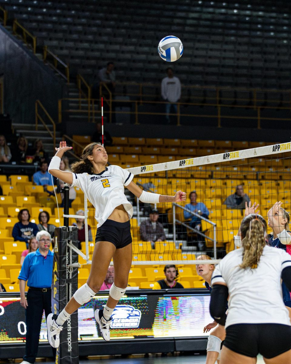 Middle blocker Maya Winterhoff bounds into the air to spike the ball against Georgia Southern on Oct. 19. Winterhoff led the team in kills against Georgia Southern with 13, and had four blocks.